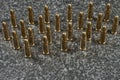 many Tokarev pistol cartridges standing on a gray granite background